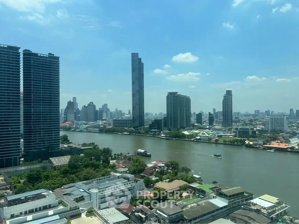Stunning cityscape view with river and skyscrapers under a clear blue sky.