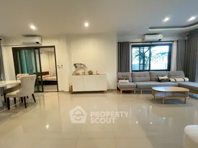 Spacious modern living room with elegant furniture and large windows for natural light.