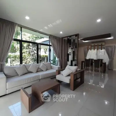 Spacious modern living room with elegant decor and large windows