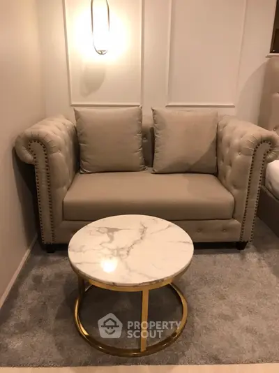 Elegant living room with plush beige sofa and chic marble coffee table