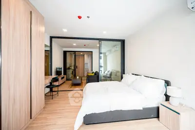 Modern bedroom with stylish decor and open view to living area