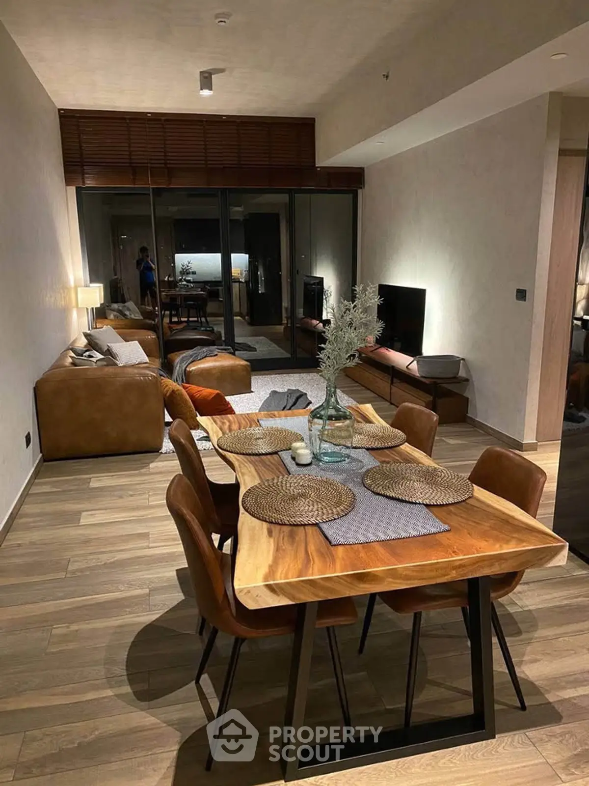 Stylish open-plan living and dining area with modern furnishings and cozy ambiance.