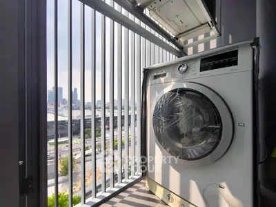 Modern balcony with washing machine and city view, perfect for urban living.