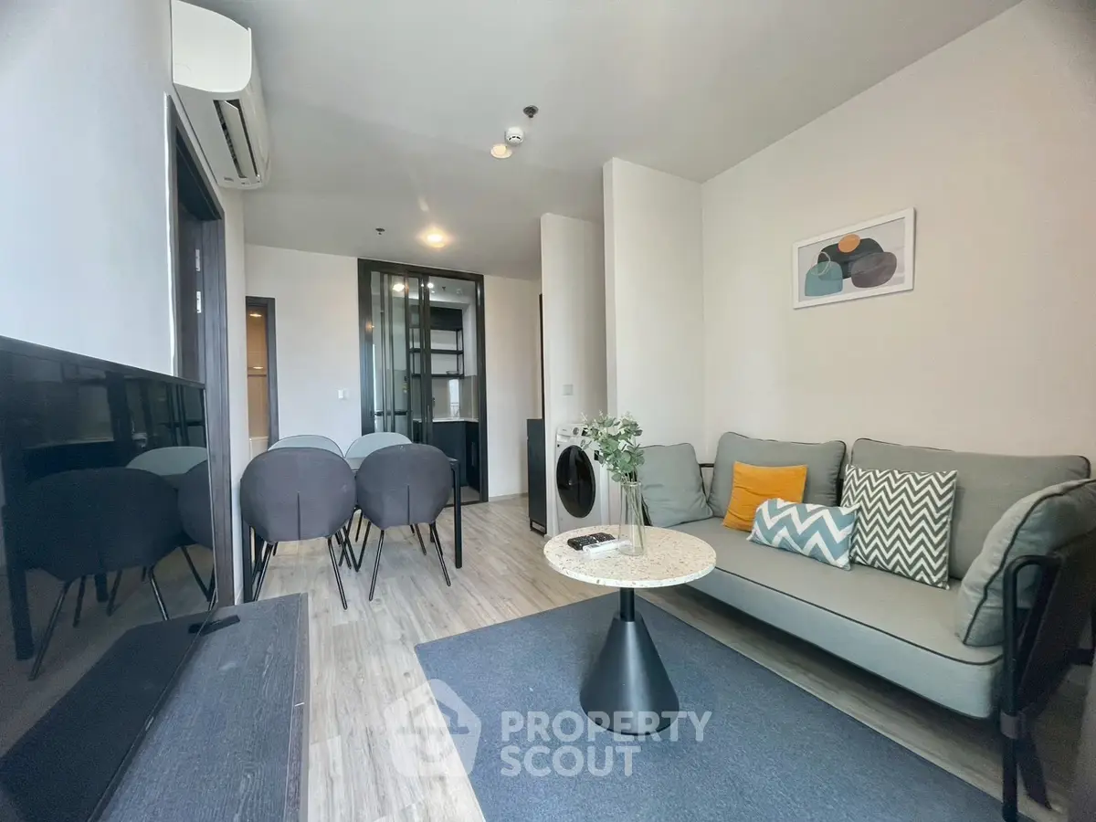Modern living room with stylish decor and open dining area