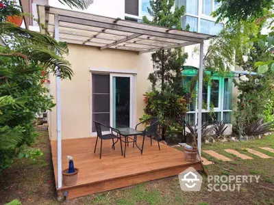 Charming backyard patio with modern pergola and lush greenery