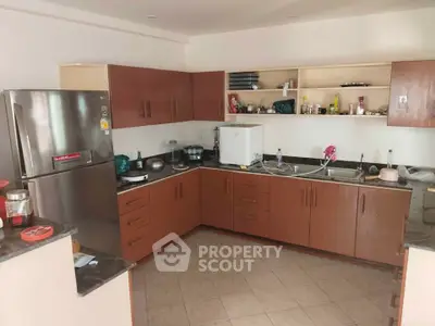 Spacious kitchen with modern appliances and ample storage in a cozy home.