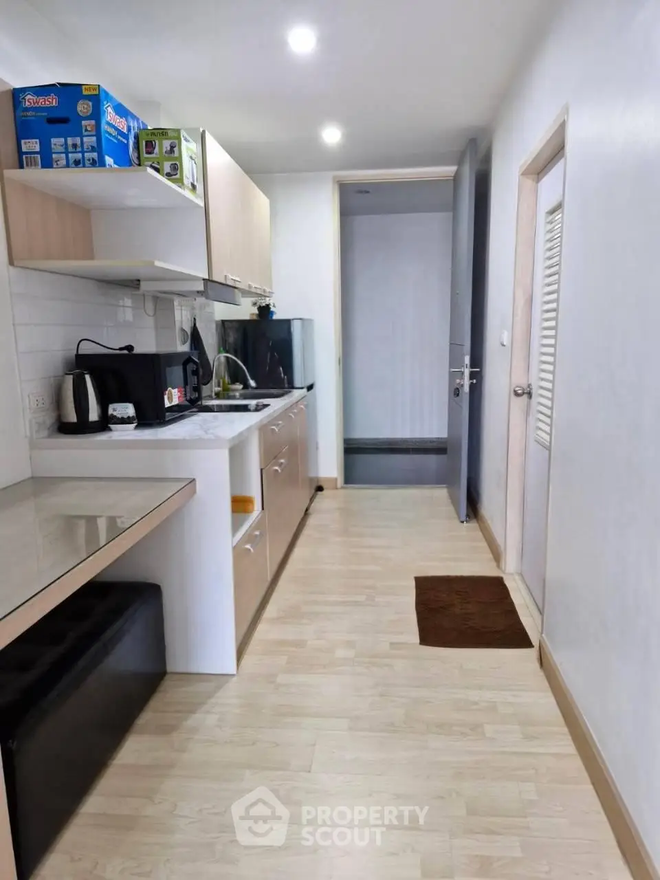 Modern kitchen with sleek cabinetry and appliances in a compact layout