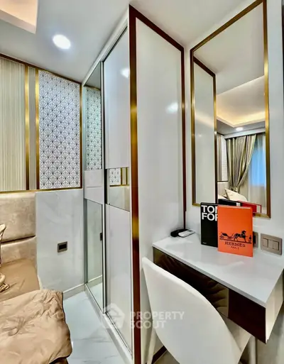 Luxurious modern bedroom with elegant decor and stylish furnishings, featuring a chic vanity area.