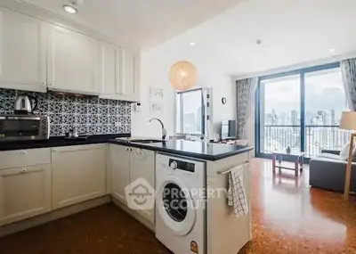 Modern open kitchen with city view, featuring washing machine and stylish decor.