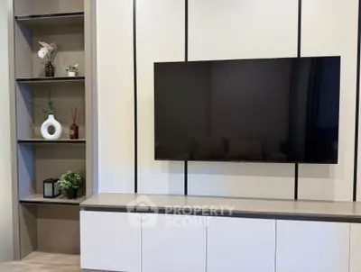 Modern living room with sleek TV setup and stylish shelving