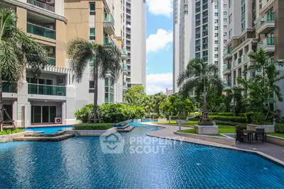 Luxurious condominium with stunning pool and lush garden view