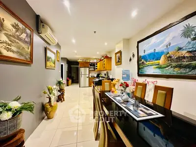 Spacious dining area with elegant decor and modern kitchen in open layout