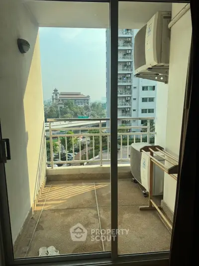 Charming balcony with city view in modern apartment, perfect for relaxation and enjoying the skyline.