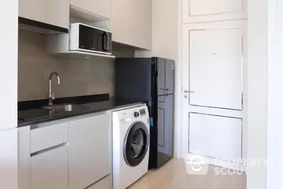 Modern compact kitchen with washing machine and microwave