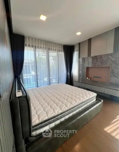 Luxurious bedroom with modern design and large windows for natural light