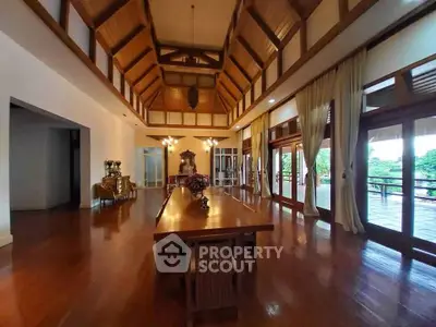 Spacious living room with high ceilings and elegant wooden decor