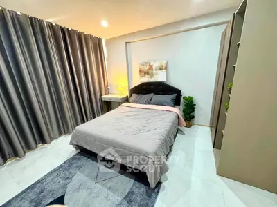 Modern bedroom with stylish decor, cozy bed, and elegant curtains in a contemporary apartment.