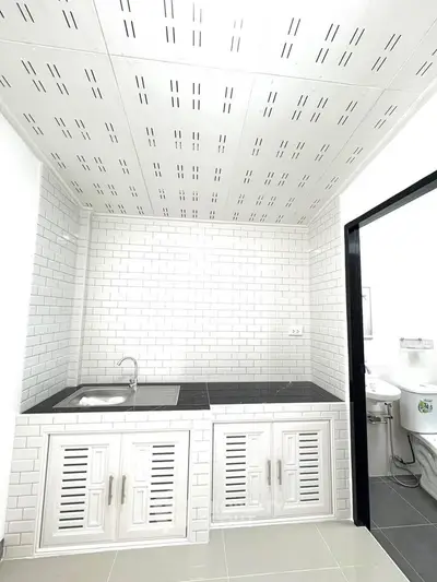 Modern kitchen with white brick tiles and sleek black countertop