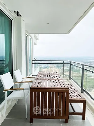 Spacious balcony with modern furniture and panoramic city view