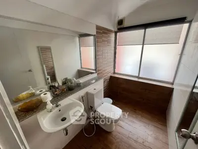 Modern bathroom with wooden accents and large mirror