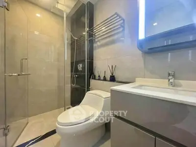 Modern bathroom with sleek fixtures and glass shower enclosure