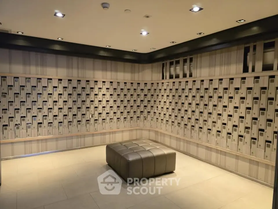 Modern building entrance with stylish mailbox wall and seating area