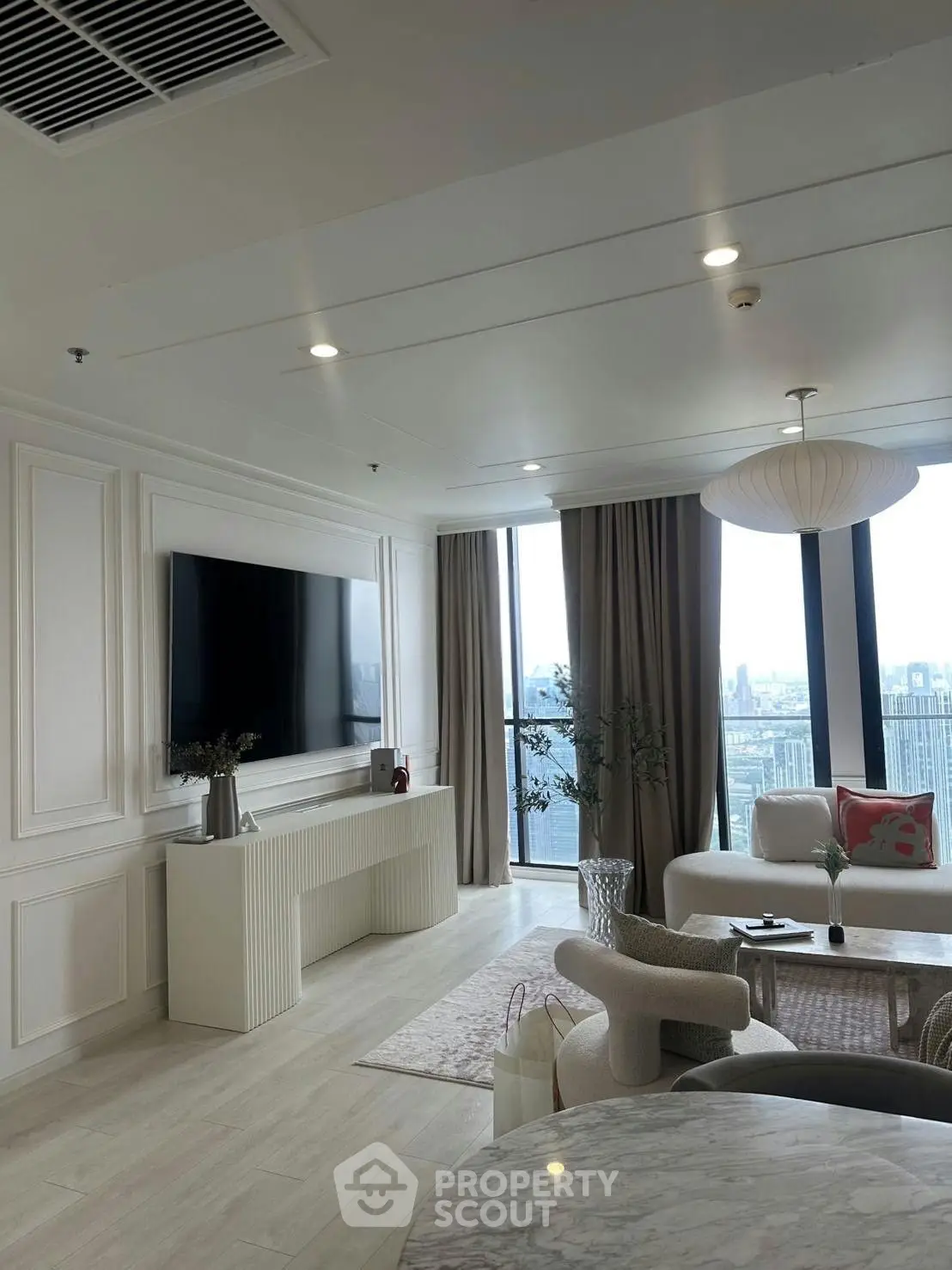 Luxurious modern living room with panoramic city view and elegant decor
