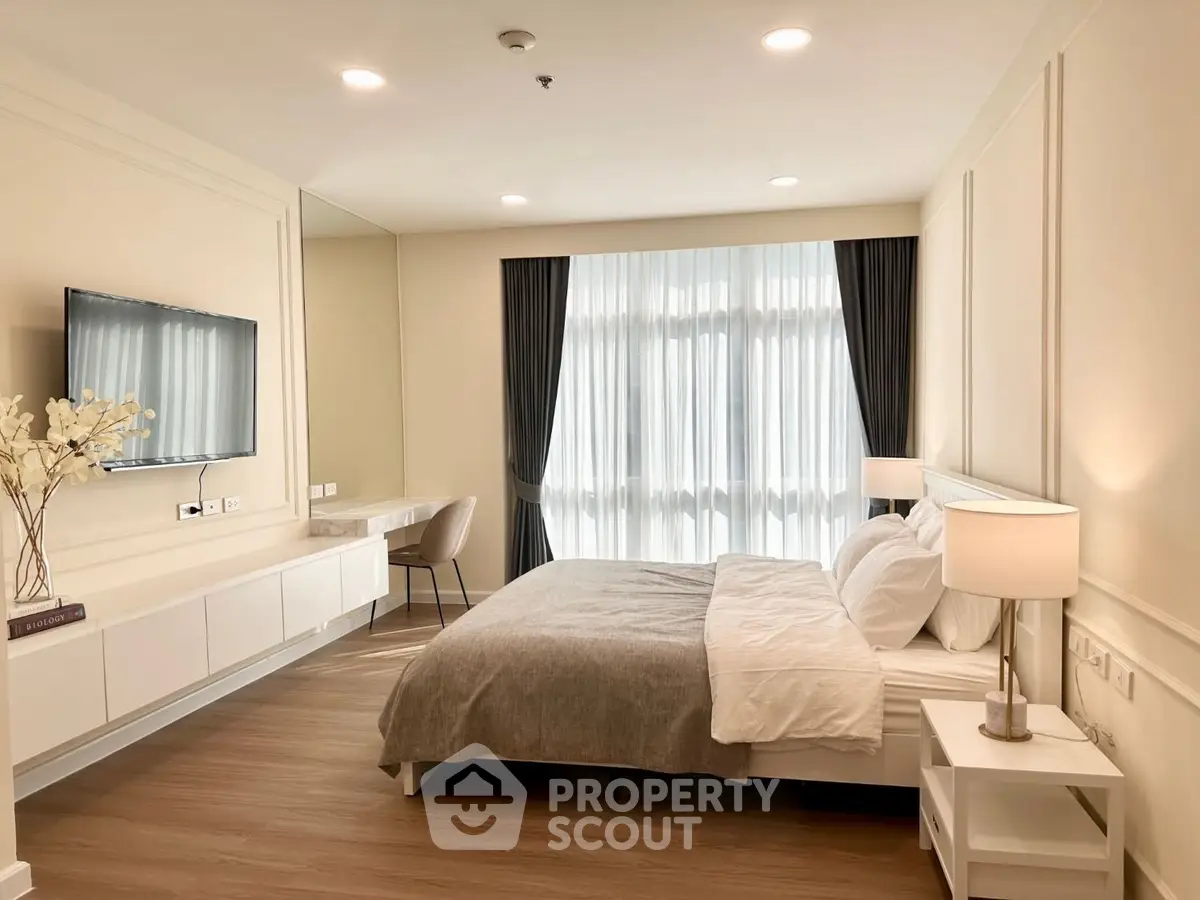 Spacious modern bedroom with elegant decor and natural light