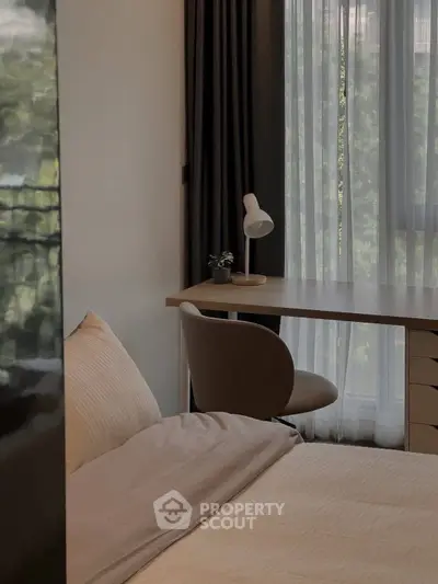 Cozy bedroom with study desk and natural light through large window