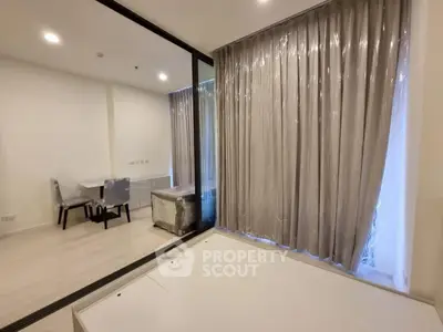 Modern apartment interior with floor-to-ceiling windows and elegant curtains