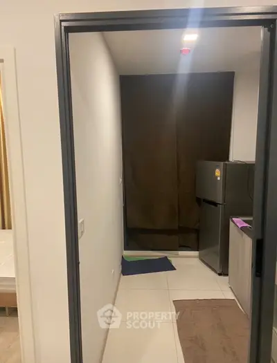 Compact kitchen area with modern fridge and minimalistic design