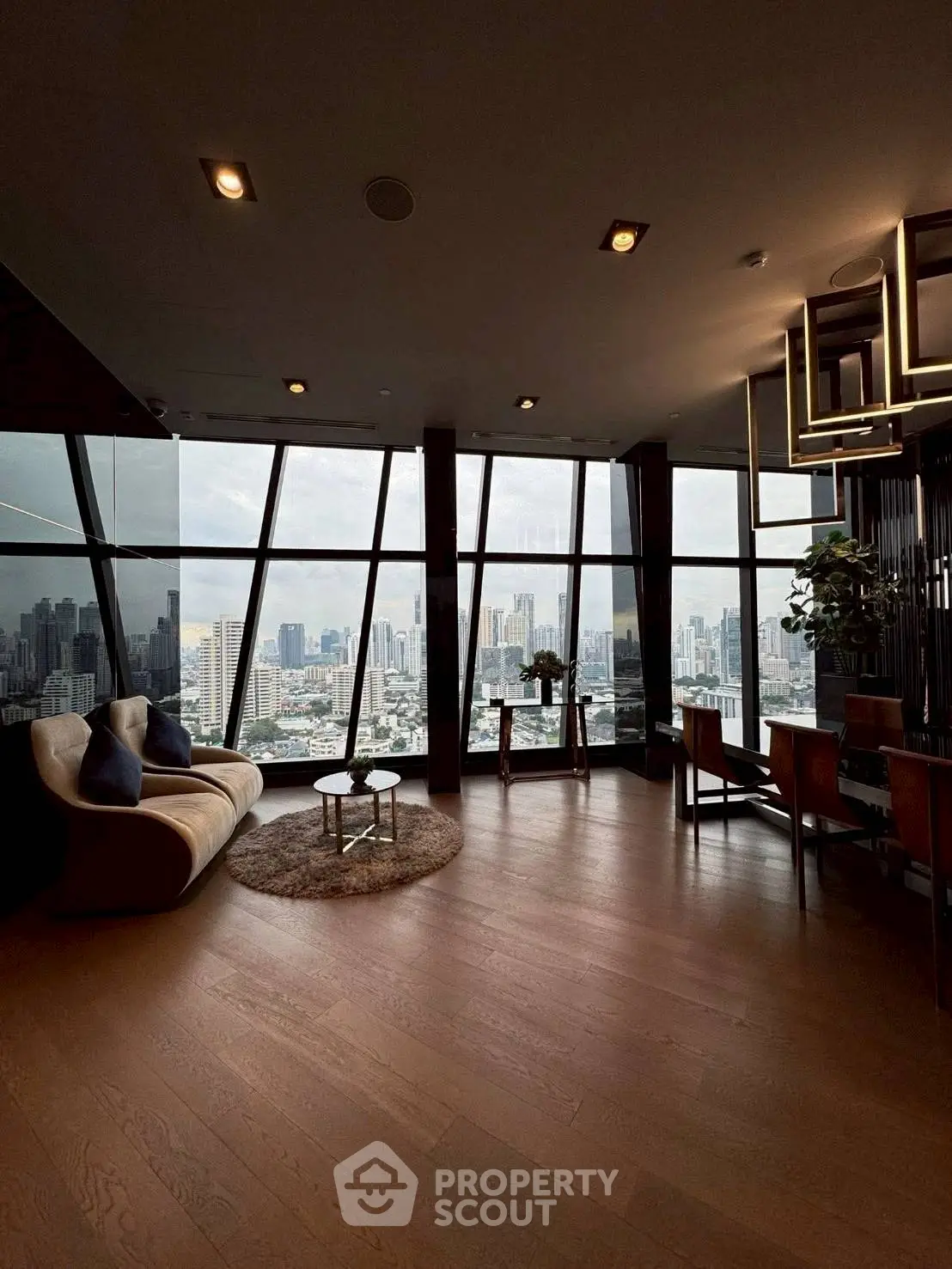 Luxurious living room with stunning city skyline view and modern furnishings.