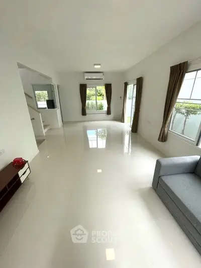 Spacious living room with modern design and large windows for natural light.