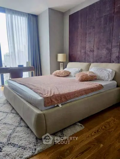 Luxurious bedroom with modern decor and city view, featuring a plush bed and elegant furnishings.