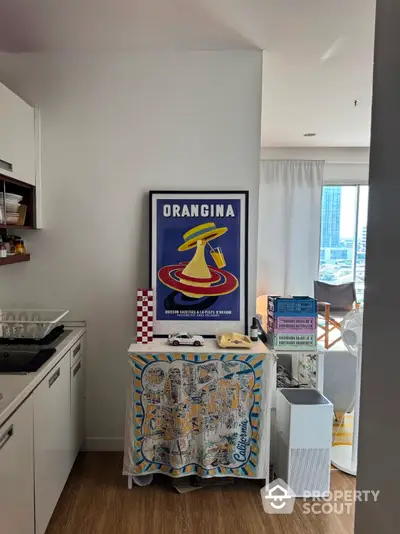 Chic kitchen corner with vintage Orangina poster and modern decor