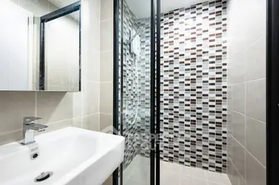 Modern bathroom with stylish tiled shower and sleek sink design