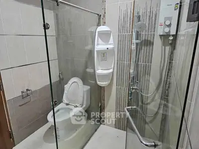 Modern bathroom with glass shower enclosure and sleek fixtures
