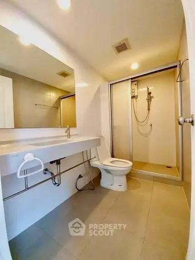 Modern bathroom with sleek fixtures and spacious shower area