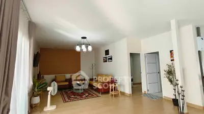 Spacious living room with modern decor and ample natural light