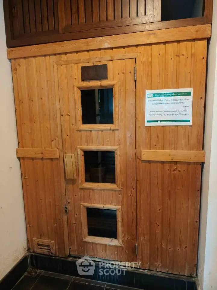 Cozy wooden sauna room with glass windows in a modern building