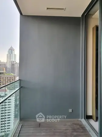 Modern urban balcony with city view and glass railing