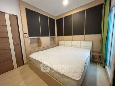 Spacious modern bedroom with sleek built-in storage and large bed, perfect for comfort and style.