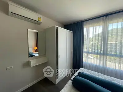 Bright bedroom with large window and modern furniture in a stylish apartment.