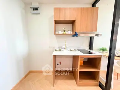 Modern compact kitchen with sleek wooden cabinets and induction cooktop