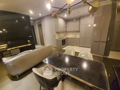 Modern open-layout kitchen and living room with sleek design and contemporary furniture.