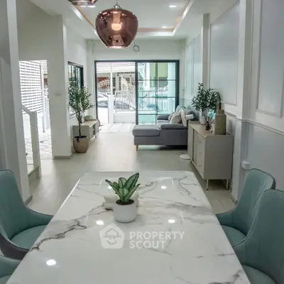 Modern open-plan living and dining area with stylish decor and natural light.