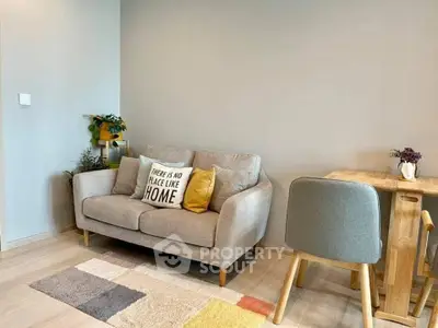Cozy living room with stylish sofa and dining area, perfect for modern living.