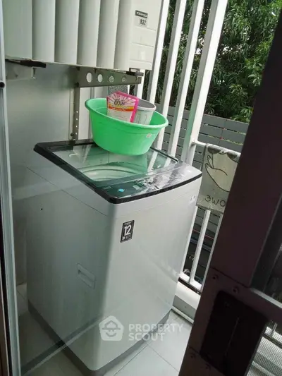 Compact balcony with washing machine and greenery view