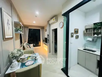 Modern open-layout living room with stylish decor and compact kitchen area