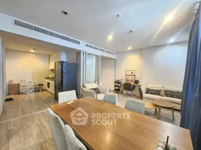 Spacious open-plan living and dining area with modern kitchen and elegant decor